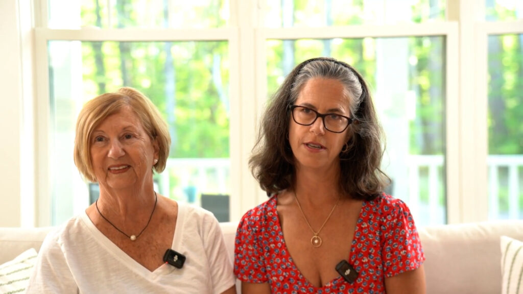 Sandra Watson and her daughter, Julie Bath, seated together during a Lady of the Lakes Estates homeowner interview about first-floor living in Laconia, New Hampshire.